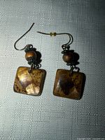 Front view of both earrings showing square drops and beads