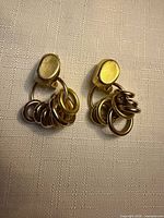 pair of gold-tone doorknocker earrings front view