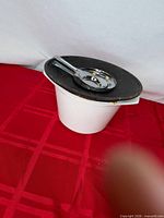 White Le Creuset pot with dark lid and ladle