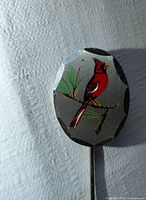 front view of enamel cardinal head of stick pin