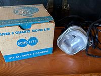 Movie light with power cord beside original box