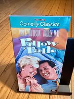 Front cover of Pillow Talk VHS slipcase showing title and actors