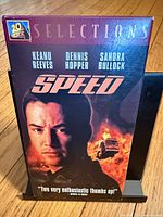 Front view of Speed VHS slipcase featuring Keanu Reeves, Dennis Hopper, Sandra Bullock credits and exploding bus artwork