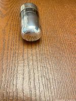 Vacuum tube side view showing 7AS marking on metal base