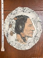 Full view of round plaque with measuring tape showing size