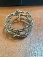Angled view of entire bronze seed bead cuff bracelet showing woven mesh design