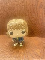 Front view of Bilbo Baggins Funko Pop figure showing hair, facial paint, outfit and wear