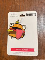 Front view of Hallmark Fortnite Durrr Burger ornament on original backing card