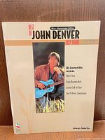 Front cover showing title and John Denver photo