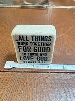 Front view showing full Romans 8:28 text and tape measure indicating 2.5 in width