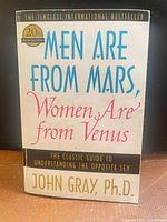 Front cover of book showing title, author, anniversary badge