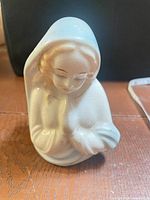 Front view showing praying figure, color details and crazing