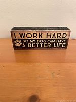 Front view of wooden block sign showing printed quote