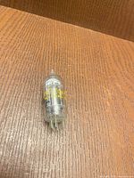 Raytheon 7-pin miniature vacuum tube front view showing yellow model print and pin base