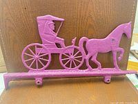Full view of pink cast metal horse & carriage wall hook