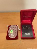 Red velvet pouch with 1992 tag, and open red velvet Waterford presentation box with booklet