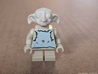 Front view of Dobby minifigure showing printed torso and sculpted head