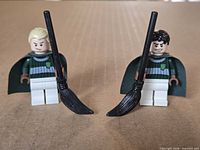 Front view of both minifigures standing with brooms
