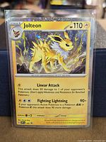 Front view of sleeved Jolteon Cosmos Holo promo card