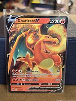Front of sleeved Charizard V card showing artwork, HP, attacks