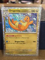 Front of Dragonite holo card in sleeve showing holographic surface, HP, ability and attack