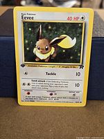 Front of Eevee Team Rocket 1st Edition card showing artwork, set symbol and 55/82 numbering