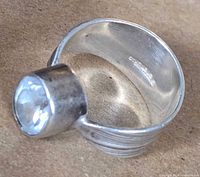 Interior view showing 925 mark, bezel-set stone, wide band