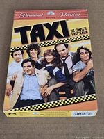Front of Taxi Complete First Season DVD box showing title and main cast
