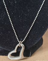 Close-up of pendant showing heart shape and chain detail