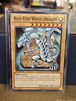 Front of the Blue-Eyes White Dragon card in protective sleeve