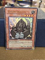 Front view of Golem Dragon promo card showing gold rare foiling and card details