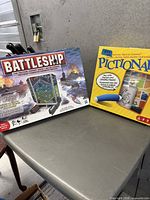Battleship and Pictionary game boxes side by side