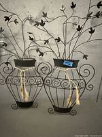 Both metal wall art pieces side by side showing full design