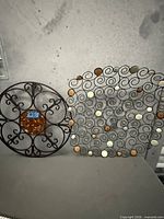 Both metal wall art pieces side by side