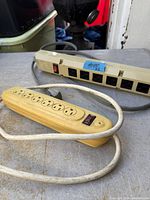 Both power strips showing outlet faces and cords