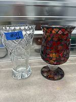 Crystal vase left, mosaic stained-glass candle holder right, side-by-side