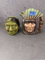 Front view of both ceramic Native American character cups