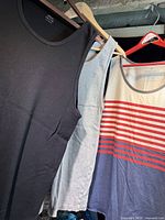 All three tank tops hanging: black, grey, stripe