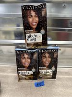 Three Clairol Nice’n Easy Pure Brunette hair dye boxes stacked
