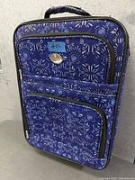 front view of blue patterned carry-on suitcase