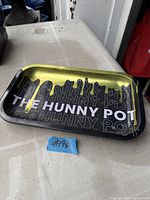 Top view of rectangular metal tray with The Hunny Pot branding