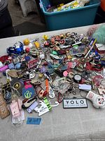 Overall view of large pile of assorted keychains on table