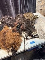 Table view of assorted hairpieces in various colors and textures