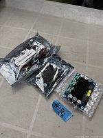 One PCB exposed, two boards sealed in anti-static bags
