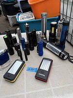Full lot of assorted flashlights on table