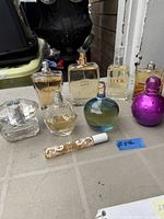 Front view of all perfume bottles and rollerball on tabletop