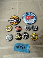 All nine buttons and patch arranged on flat surface