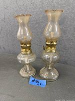 Two miniature opalescent glass oil lamps with brass burners and chimneys