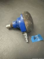 Side view of blue palm nailer showing rubber grip and air fitting