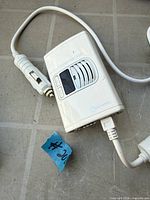 Front view showing controls, vent grille, and brand logo